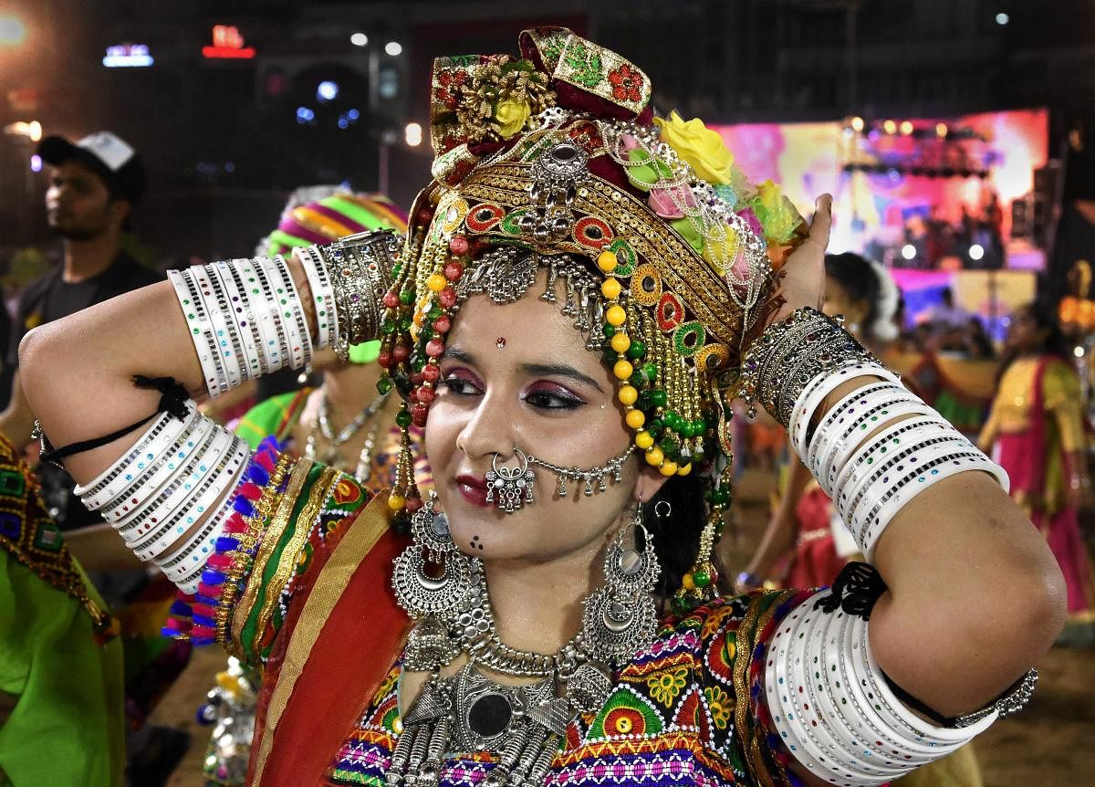 A devotee participates in a Garba dance performance during the Navratri festival celebrations, in Bhopal. PTI