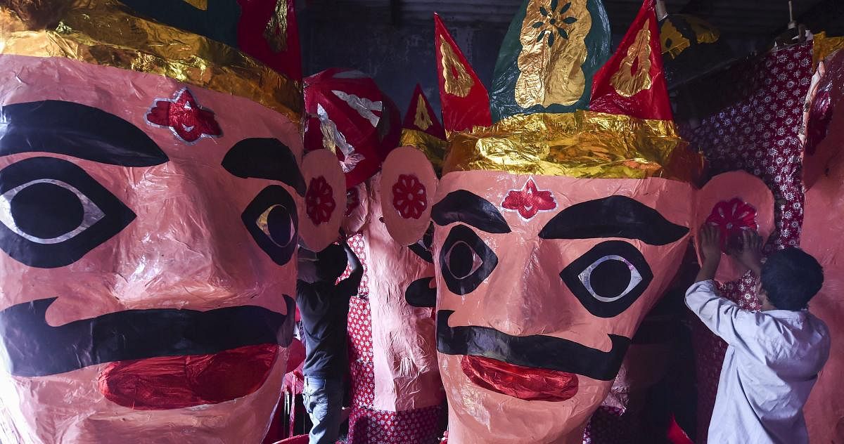 Artisans prepare effigies of demon-king Ravana at a workshop, ahead of Dussehra festival celebrations, in Ahmedabad. PTI