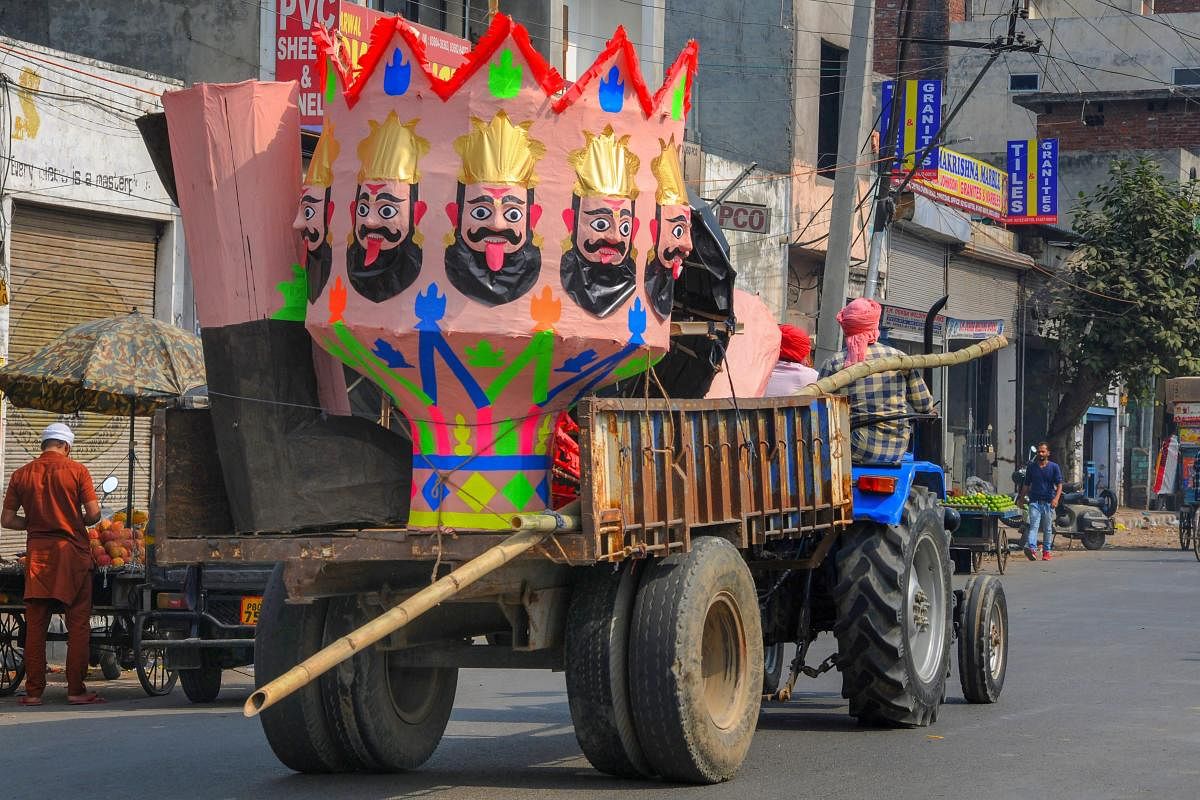 An effigy of demon-king Ravana being carried on a tractor trolley for installation, ahead of Dussehra festival, in Amritsar. PTI