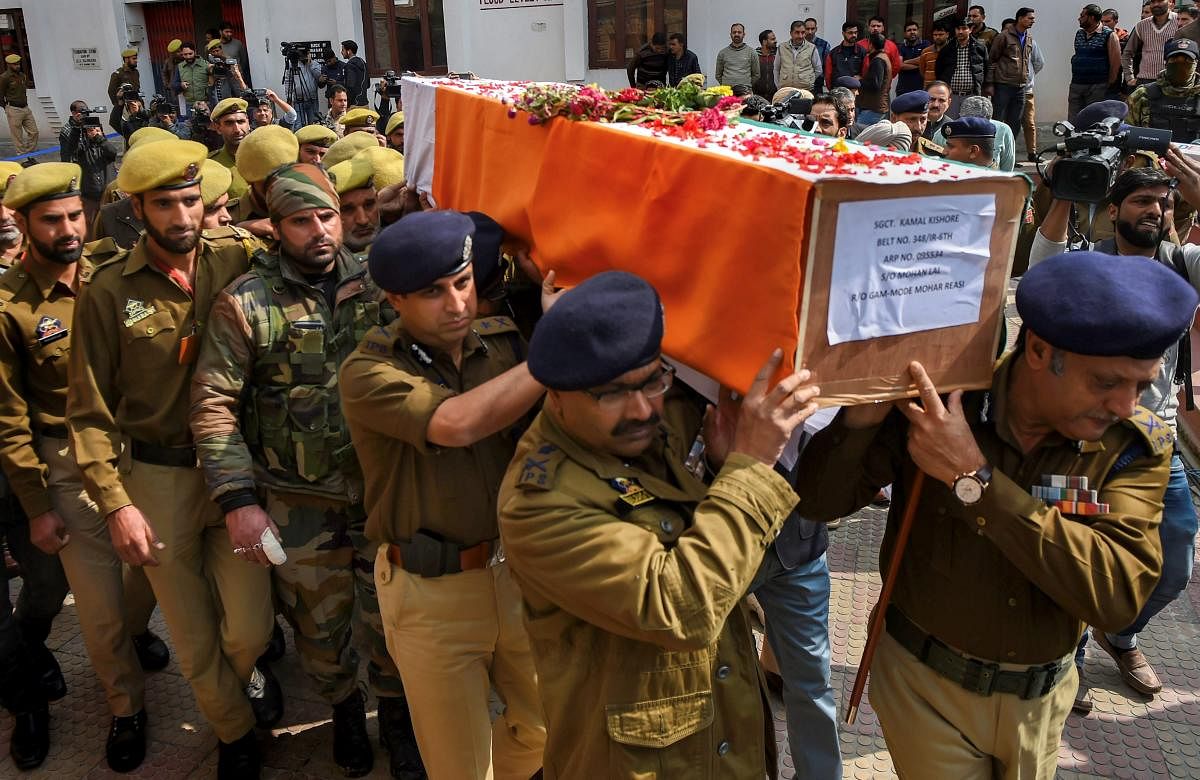 Senior Police officers carry the coffin of their colleague constable Kamal Kishore, who was killed in an encounter with militants at Fateh Kadal, during wreath-laying ceremony, in Srinagar. A policeman of Special Opration Group (SOG) three militants including a over ground worker (OGW) were killed in the gun battle. PTI