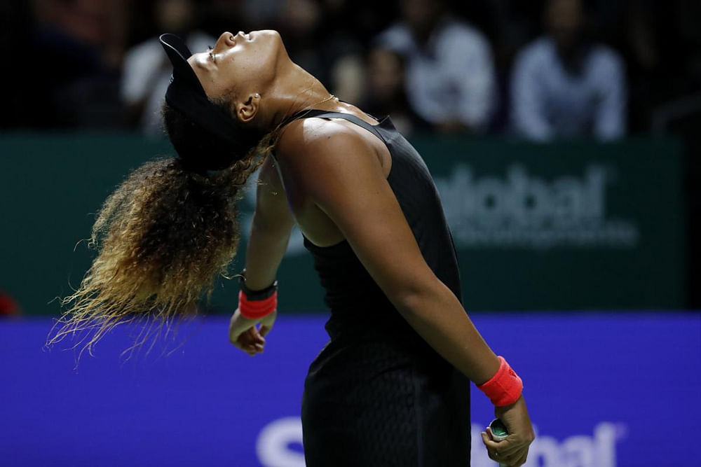Naomi Osaka of Japan throws her head back while reacting during her women's singles match against Sloane Stephens of the United States at the WTA tennis tournament in Singapore on Monday. AP/PTI Photo