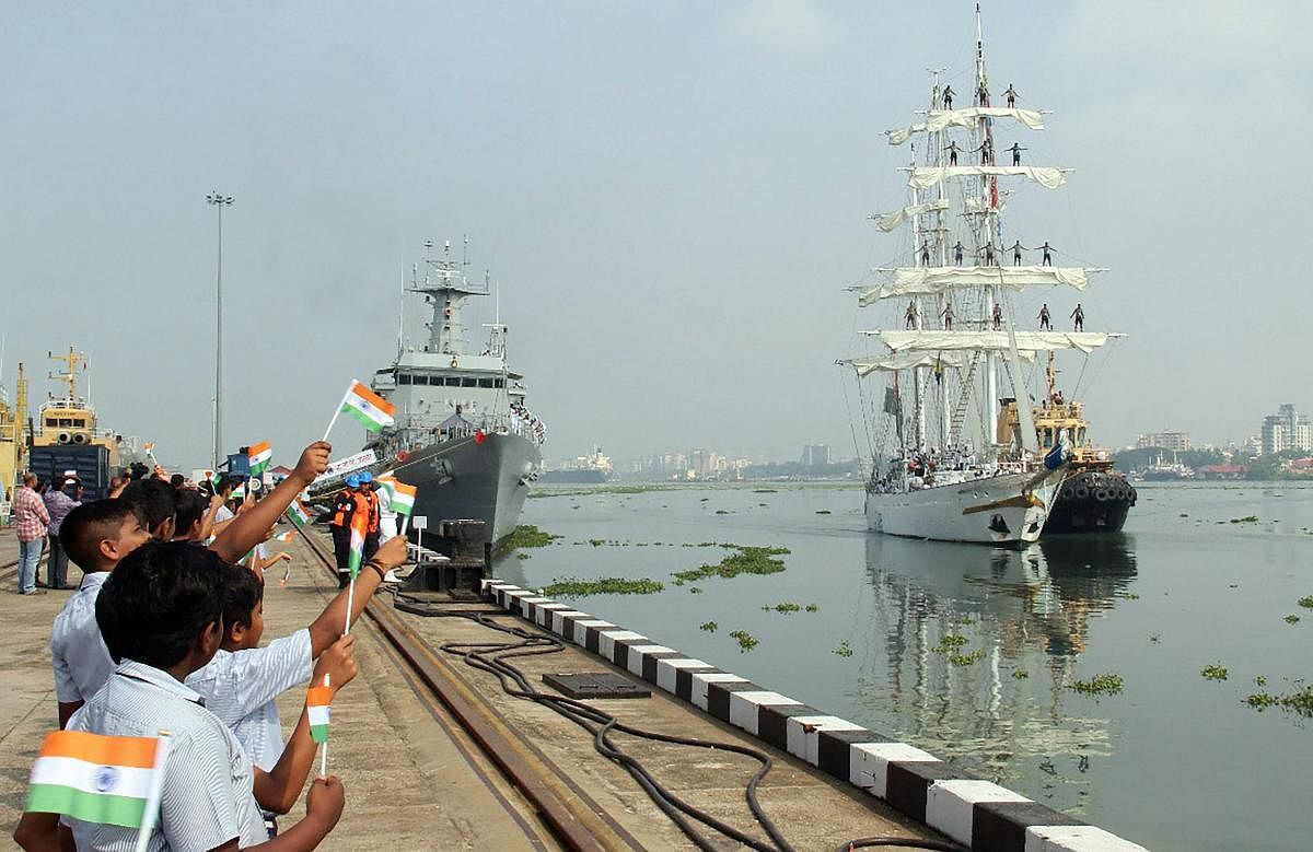 School children wave the Indian tricolour to welcome INS Tarangini which returned to Southern Naval Command, in Kochi, Tuesday, Oct 30, 2018. (PTI Photo)