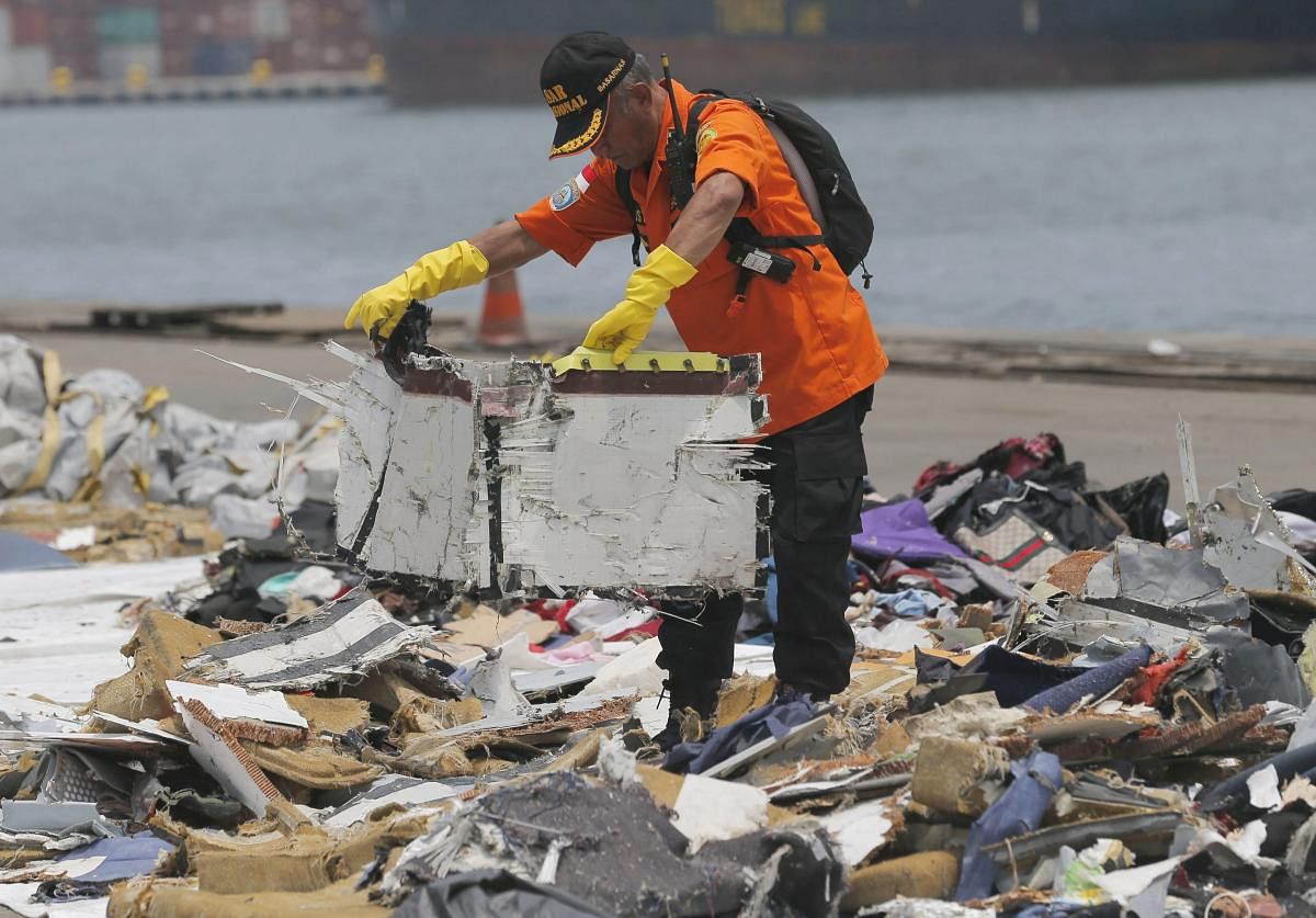 A rescuer inspects parts of Lion Air Flight 610 retrieved from the waters off Tanjung Priok Port in Jakarta, Indonesia, Wednesday, Oct. 31, 2018. A massive search effort identified the possible seabed location of the crashed Lion Air jet, Indonesia's military chief said Wednesday, as experts carried out the grim task of identifying dozens of body parts recovered from a 15-nautical-mile-wide search area. AP/PTI