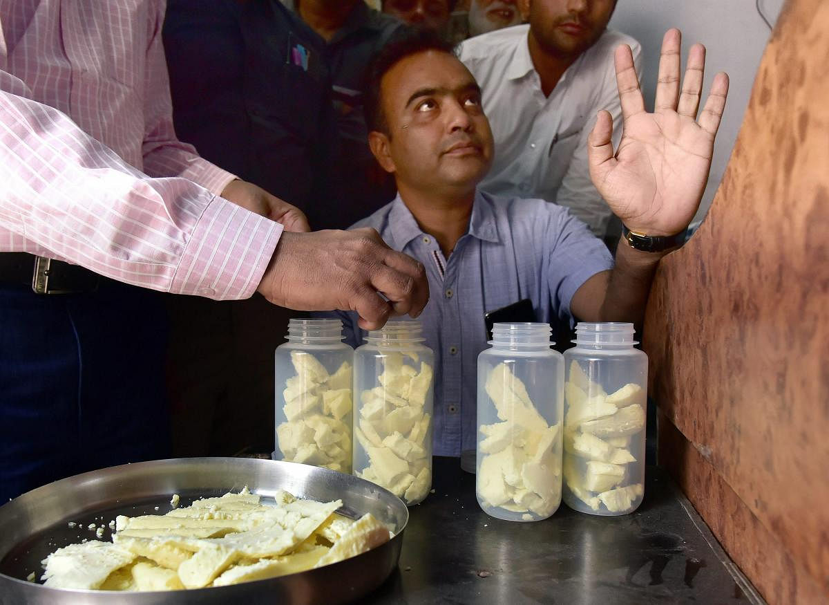 Vigilance officer of Health Department collects samples of 'Mava', a dairy product used in making traditional sweets, ahead of 'Diwali' festival at a market, in Bikaner, Friday, Nov 02, 2018. (PTI Photo)