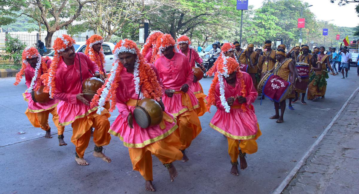 Members of Kudubi community seen dancing with their `Gumtas' in the procession organised prior to district Rajyotsava celebrations organised at Nehru Maidan, Mangaluru, on Thursday. DH photo.