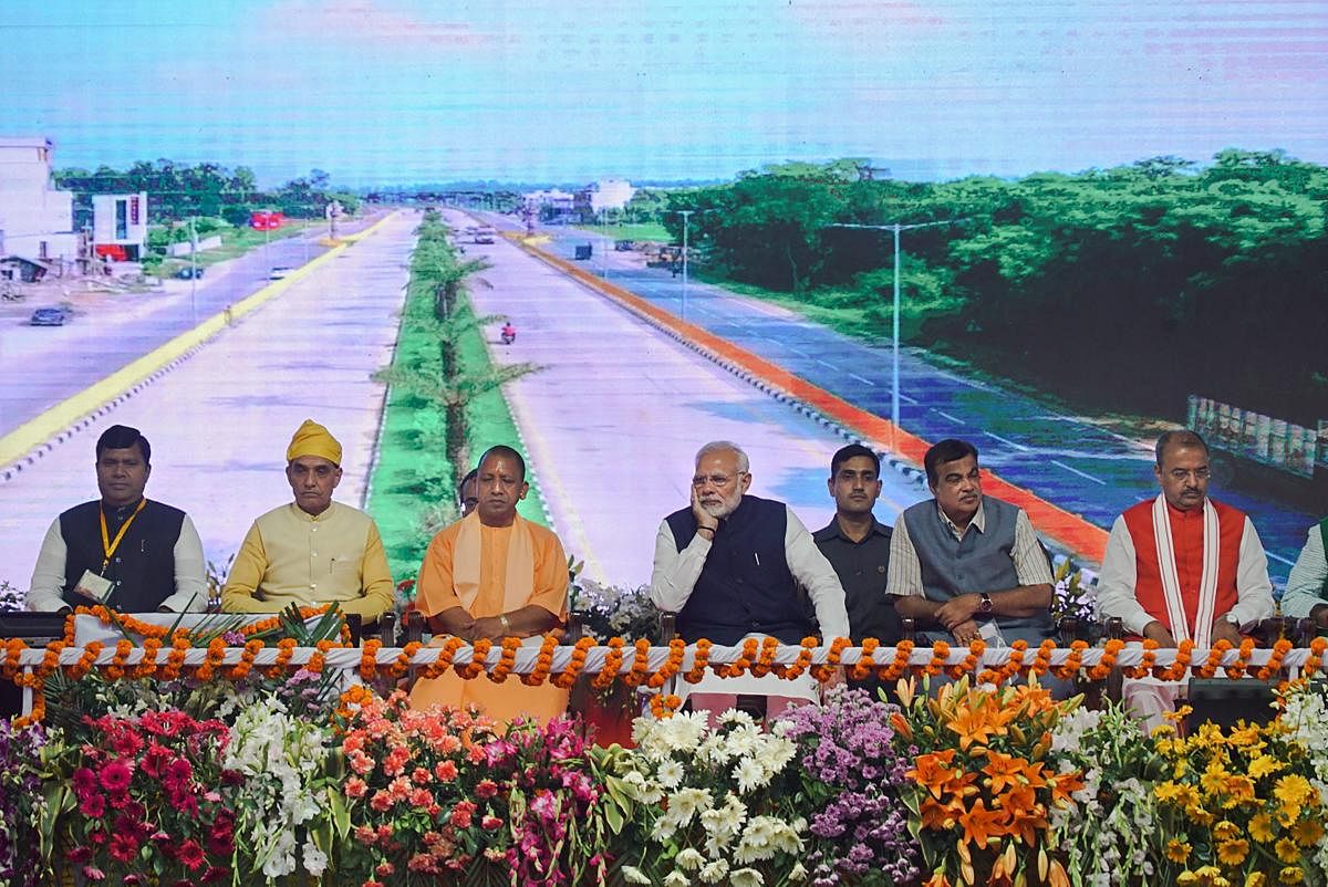 Prime Minister Narendra Modi with Union Transport Minister Nitin Gadkari, Uttar Pradesh Chief Minister Yogi Adityanath and other dignitaries during the inauguration of two major national highways and an inland waterways project, in Varanasi, Monday, Nov 12, 2018. (PTI Photo)