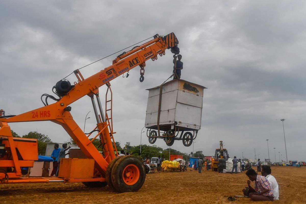 Employees of Chennai Corporation remove the stalls from the Marina beach following a government directive, in Chennai.PTI Photo