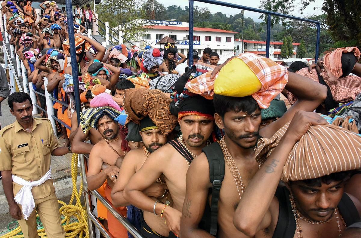Devotees queue up to offer prayers at Lord Ayyappa temple during the Malayalam month of 'Vrischikom,' in Sabarimala. PTI Photo