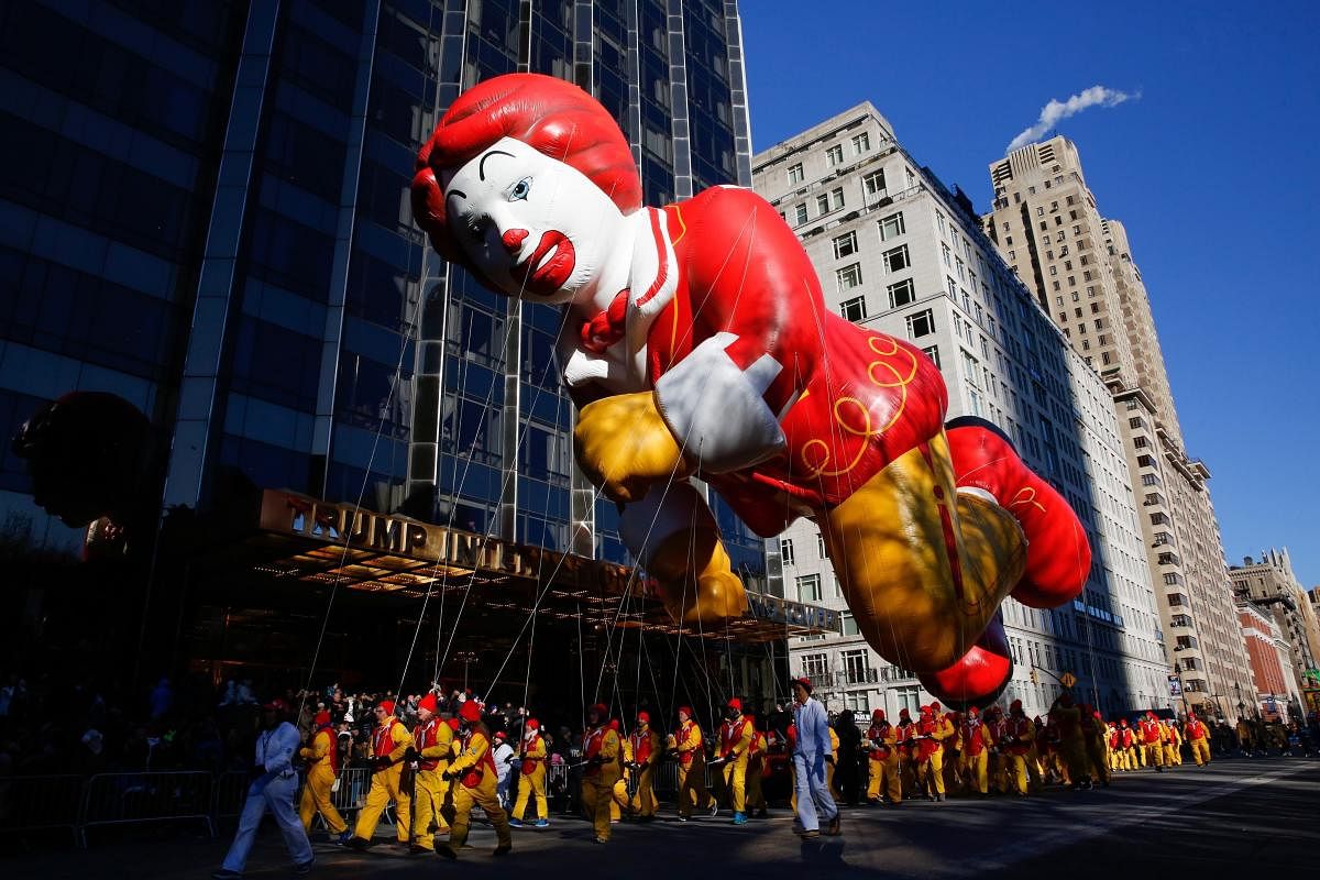 The Ronald McDonald balloon passes by windows of a building on Central Park West during the 92nd annual Macy's Thanksgiving Day Parade in New York. AP/ PTI photo