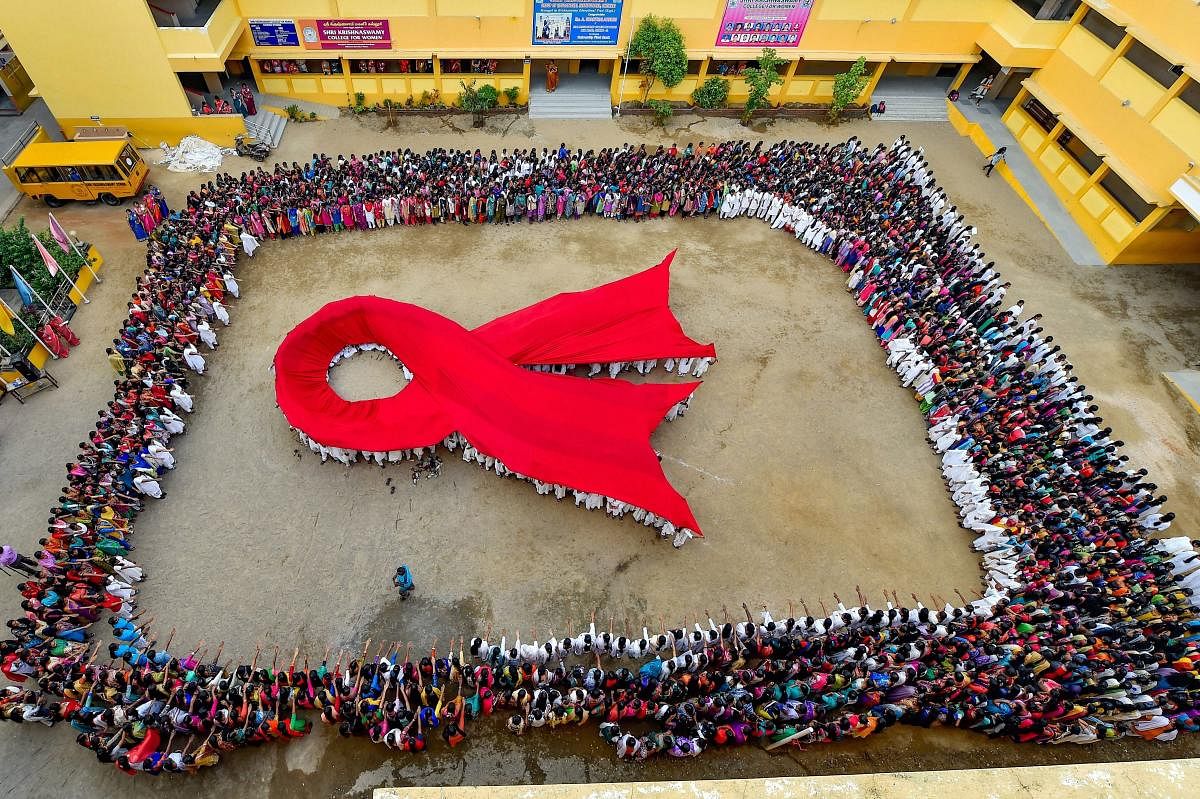 Students make a formation of AIDS symbol on the eve of World AIDS Day, in Chennai, Friday, Nov. 30, 2018. (PTI Photo)