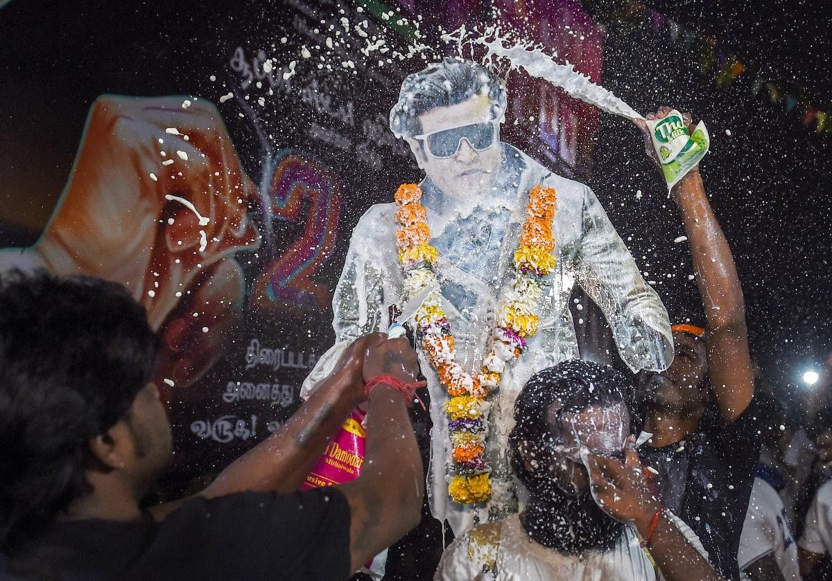 Mumbai: Fans pour milk on a cutout of Tamil actor Rajinikanth to celebrate the release of his film '2.0', in Mumbai, Thursday, Nov. 29, 2018. (PTI Photo/Shashank Parade)