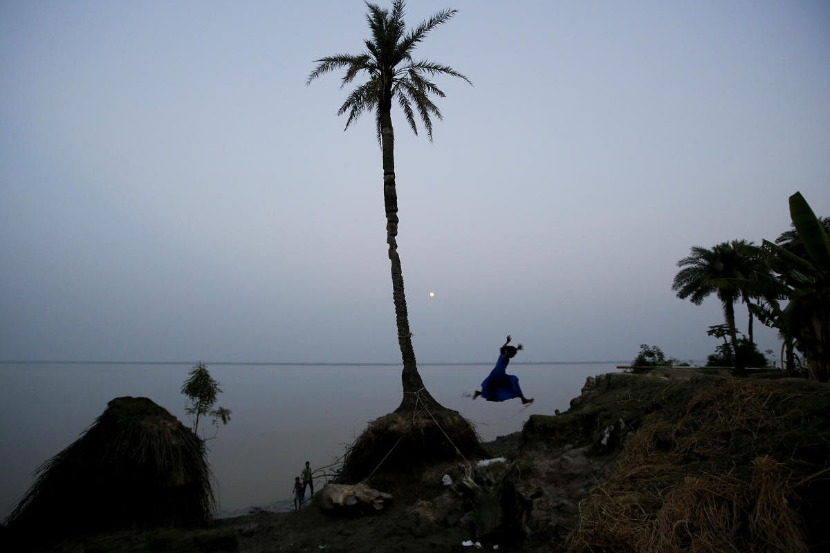 A girl plays on the coastline on Ghoramara Island, India, October 23, 2018. Ghoramara Island, part of the Sundarbans delta on the Bay of Bengal, has nearly halved in size over the past two decades, according to village elders. REUTERS/Rupak De Chowdhuri