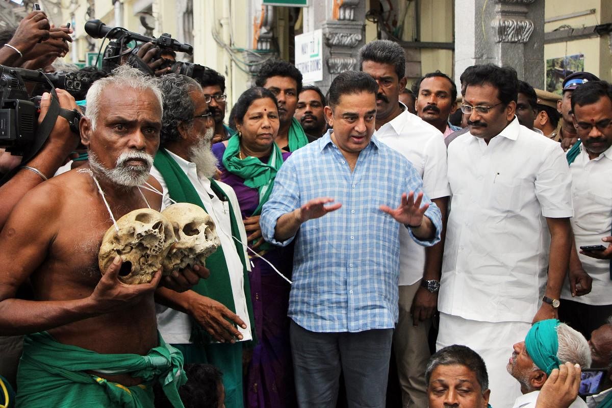 Actor and Makkal Needhi Maiam President Kamal Hassan interacts with farmers on their return from New Delhi after participating in farmers' protests, at the Egmore Railway Station in Chennai. (PTI Photo)
