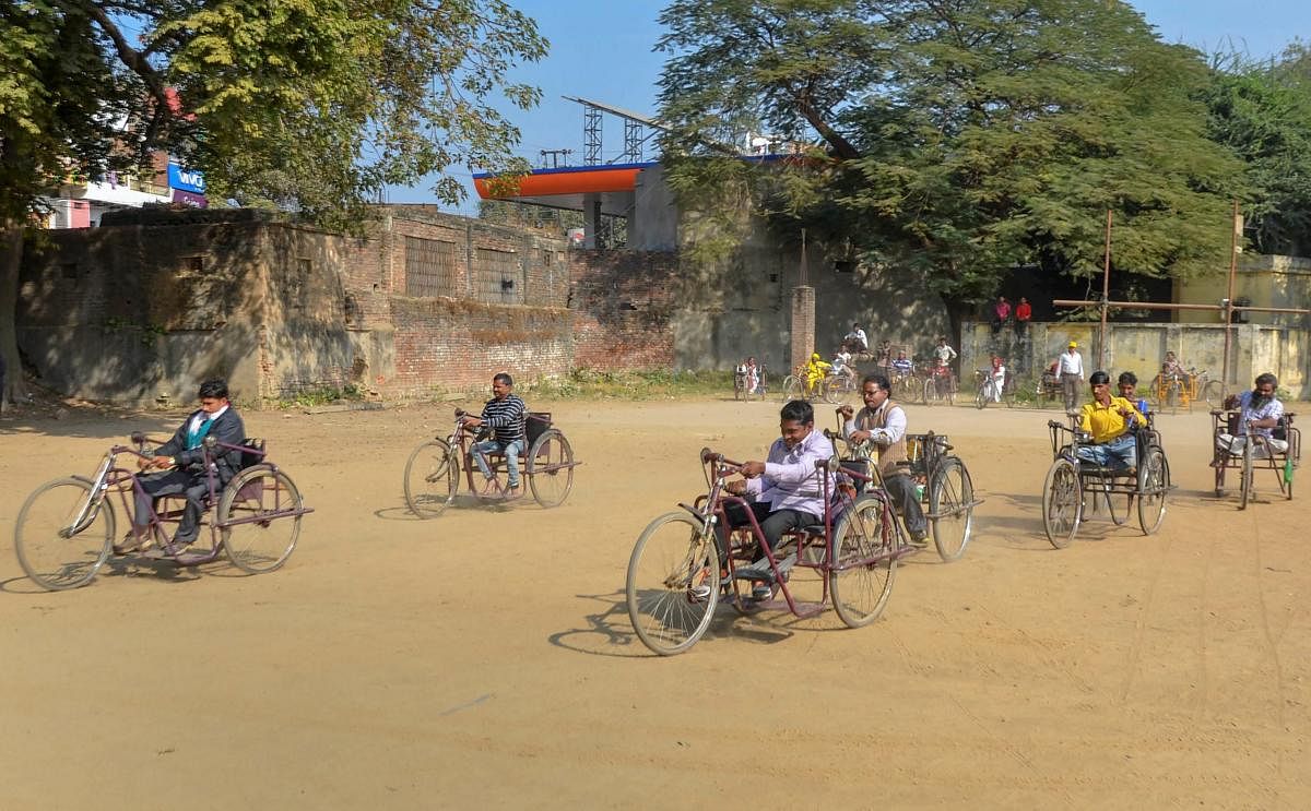 Differently abled people take part in the tricycle race to mark the 'International Day of Persons with Disabilities', in Mirzapur. (PTI Photo)