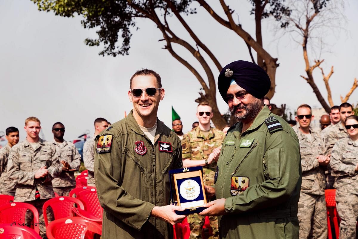 Chief of the Air Staff Air Chief Marshal BS Dhanoa presents a memento to a US Air Force contingent member participating in Ex Cope India 2018, at Air Force Station, Kalaikunda, West Bengal. (PTI Photo)