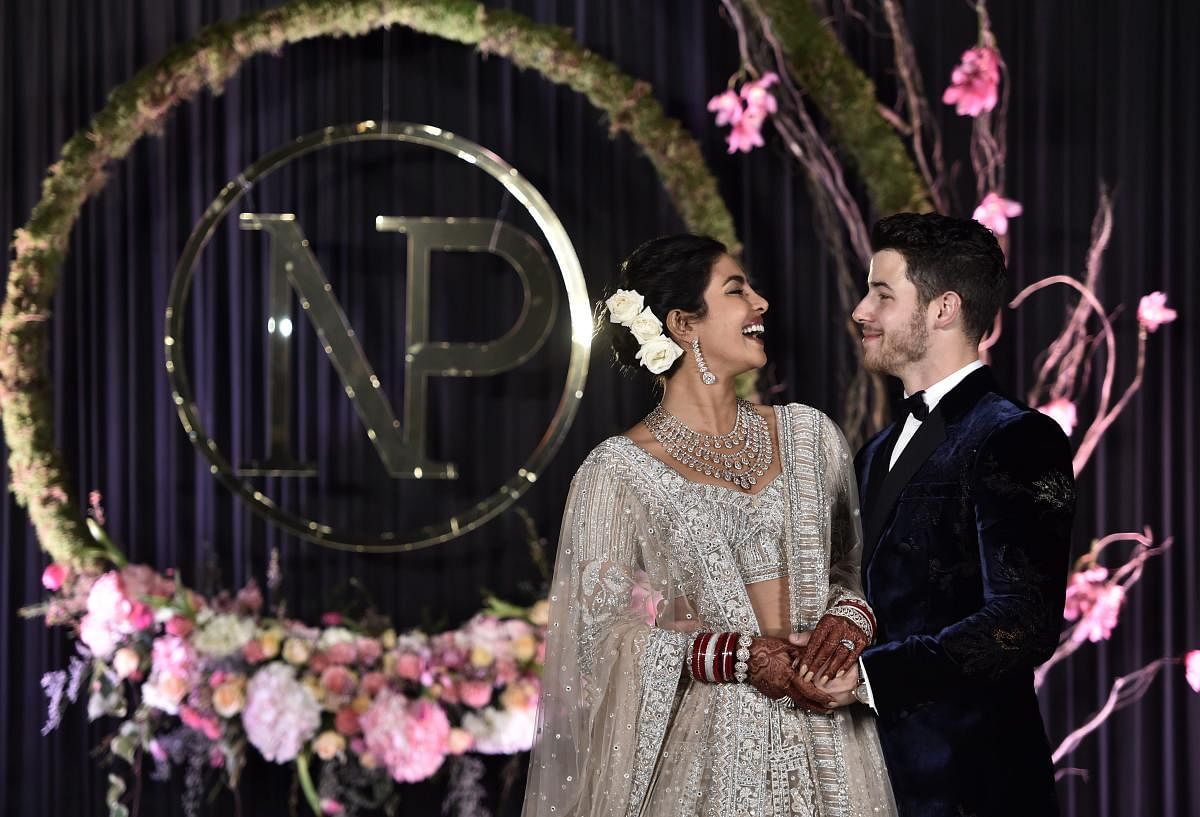 Priyanka Chopra and Nick Jonas pose for photos during their wedding reception, in New Delhi. (PTI Photo)