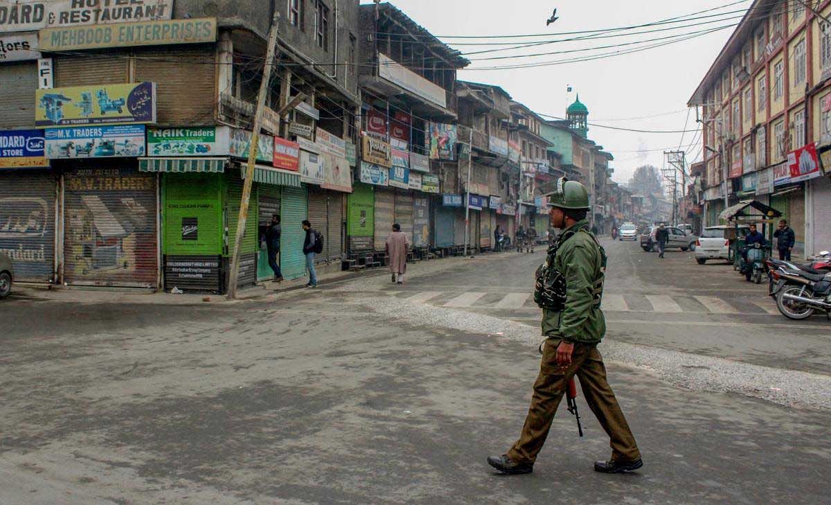 A security personnel patrols across a street during a strike call given by joint Hurriyat leadership on Human Rights Day, in Srinagar, Monday, Dec. 10, 2018. (PTI Photo)