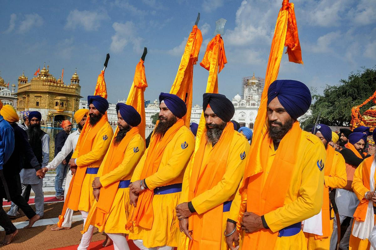 Sikh devotees participate in a 'nagar kirtan' procession at Sri Harmandir Sahib (Golden Temple) on the eve of the 343rd martyrdom day of ninth Sikh guru Guru Tegh Bahadur, in Amritsar, Tuesday, Dec 11, 2018. (PTI Photo)