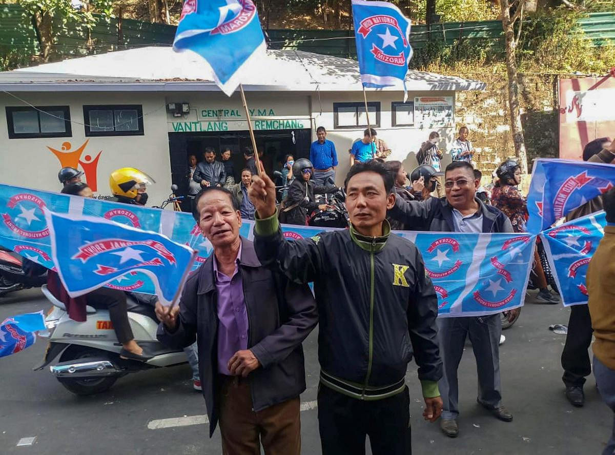 Mizo National Front (MNF) workers hold their party flag as they celebrate the party's victory in the states Assembly elections, at Party head office, in Aizawl, Tuesday, Dec. 11, 2018. (PTI Photo)