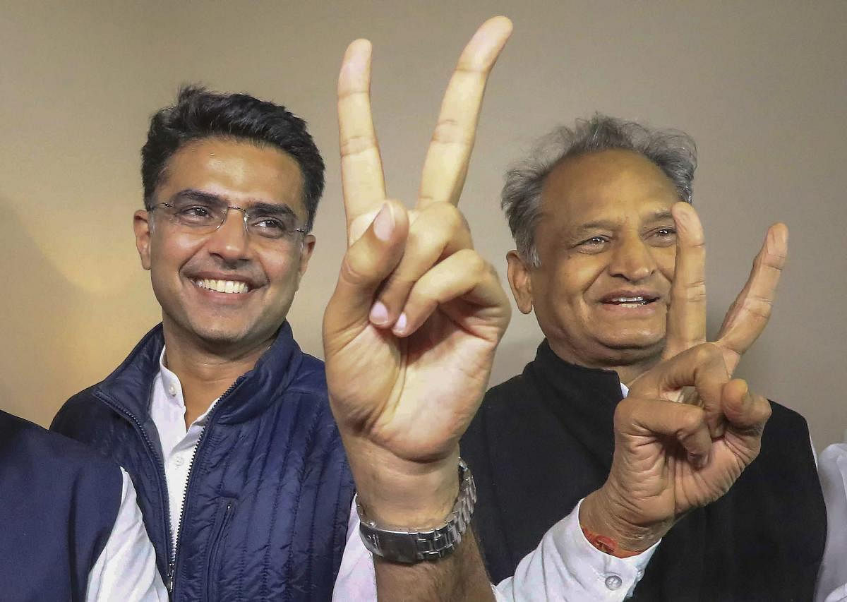Congress leaders Ashok Gehlot (R) and Sachin Pilot (C) flash victory signs after the declaration of Rajasthan Assembly election result, in Jaipur, Tuesday, Dec. 11, 2018. (PTI Photo)