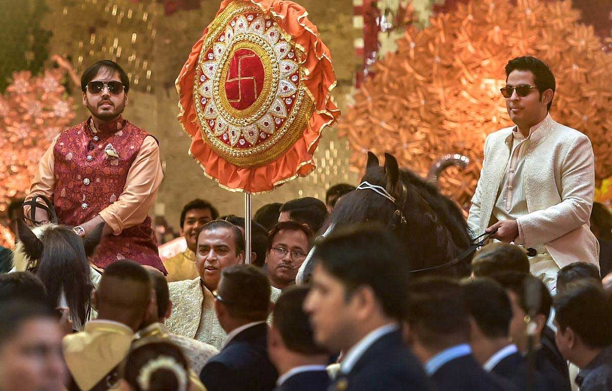 Industrialist Mukesh Ambani with sons Anant and Akash wait for the arrival of the groom, Anand Piramal, at their residence, Antilla, on the wedding day, in Mumbai, Wednesday, Dec. 12, 2018. (PTI Photo)