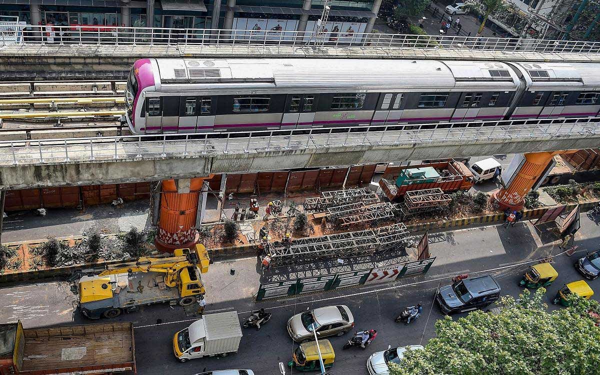 A metro train runs on the elevated corridor, as work to fix the damaged pillar underneath is in progress, in Bengaluru, Wednesday, Dec. 12, 2018. (PTI Photo)