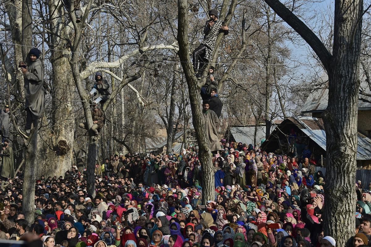 People attend the funeral of civilians and militants who were killed in the encounter between security forces and militants, in Pulwama, south Kashmir, Saturday. PTI photo