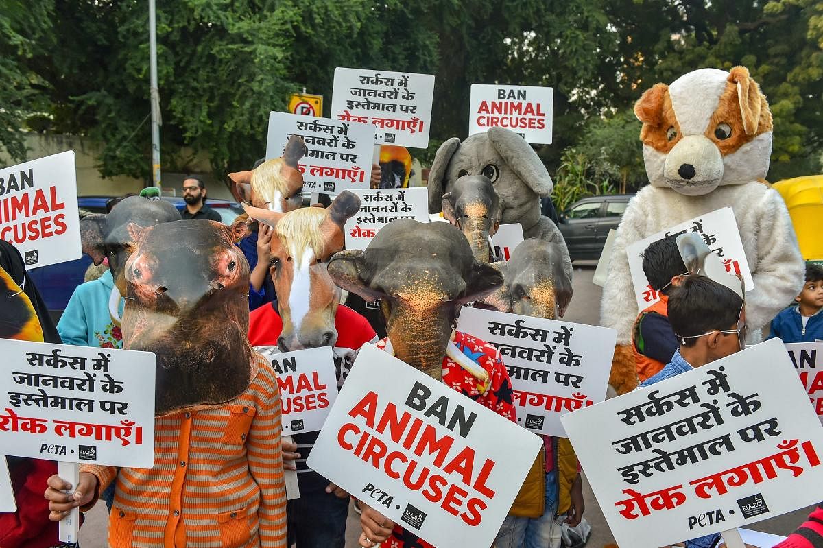 Children, wearing masks of animals, take part in a protest to urge government to end use of animals in circuses, in New Delhi, Saturday. PTI photo