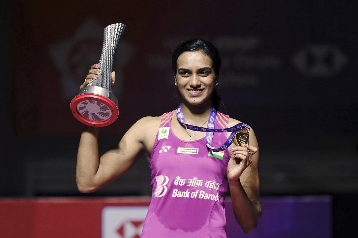 Pusarla V. Sindhu of India holds the winner's trophy after beating Nozomi Okuhara of Japan in their women's badminton singles final at the BWF World Tour Finals in Guangzhou in southern China's Guangdong province, Sunday, Dec. 16, 2018. AP/PTI