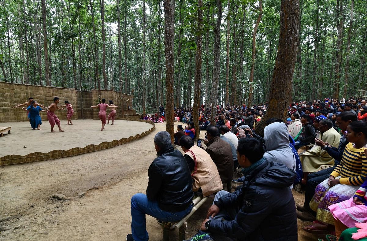 Spectators attend a perform during the 'Under the Sal Tree' festival in Rampur village, some 140km from Guwahati, on December 17, 2018. - 'Under the Sal Tree' is a three day traditional theatre festival located in the middle of a jungle which aspires to raise environmental awareness and reconnect man with nature. (Photo by Biju BORO / AFP)