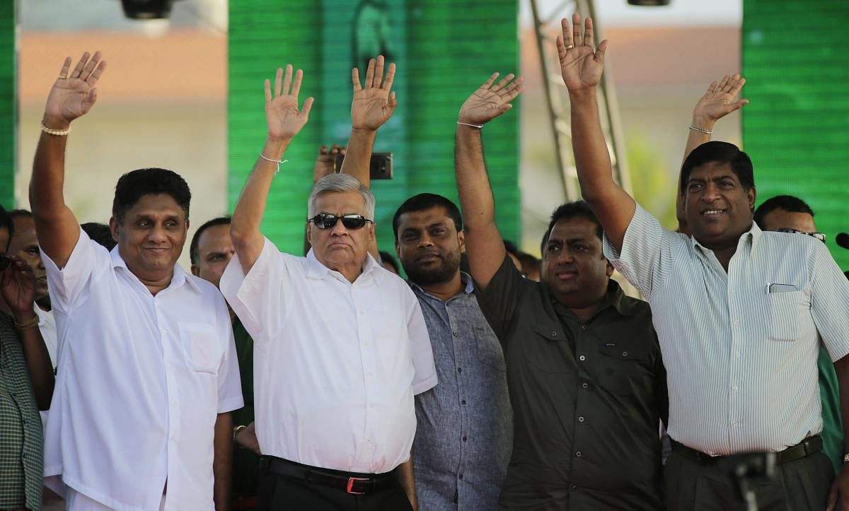 Sri Lanka's reinstated prime minister Ranil Wickremesinghe, second left, along with his loyal lawmakers from left, Sajith Premadasa, Akila Kariyawasam and Ravi Karunanayake wave to their supporters during a rally in Colombo, Sri Lanka, Monday, Dec. 17, 2018. AP/PTI