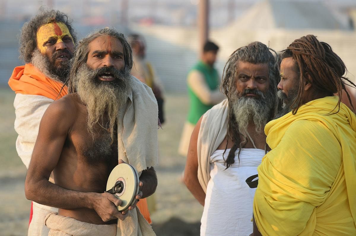 Indian sadhus of Digamber Akhada mark their land during the land allotment of the Kumbh Mela festival, on the bank of the Gange river in Allahabad on December 19, 2018. - The Kumbh Mela in the town of Allahabad will see millions of Hindu devotees gather from January 15, 2019 to March 4, 2019 to take a ritual bath in the holy waters, believed to cleanse sins and bestow blessings. (Photo by SANJAY KANOJIA / AFP)