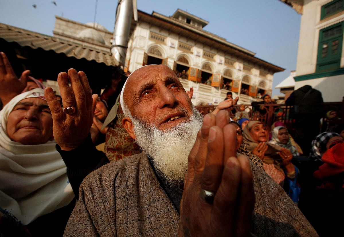 Muslims pray upon seeing a relic of Sheikh Abdul Qadir Jeelani, a Sufi saint, also known as Shah-e-Baghdad (King of Baghdad), being displayed at his shrine during his death anniversary in Srinagar December 19, 2018. REUTERS/Danish Ismail