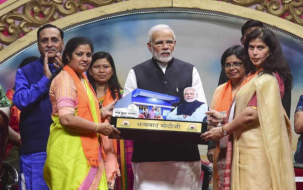 Prime Minister Narendra Modi being felicitated by BJP women's wing leaders during their National Convention, in Ahmedabad. PTI Photo
