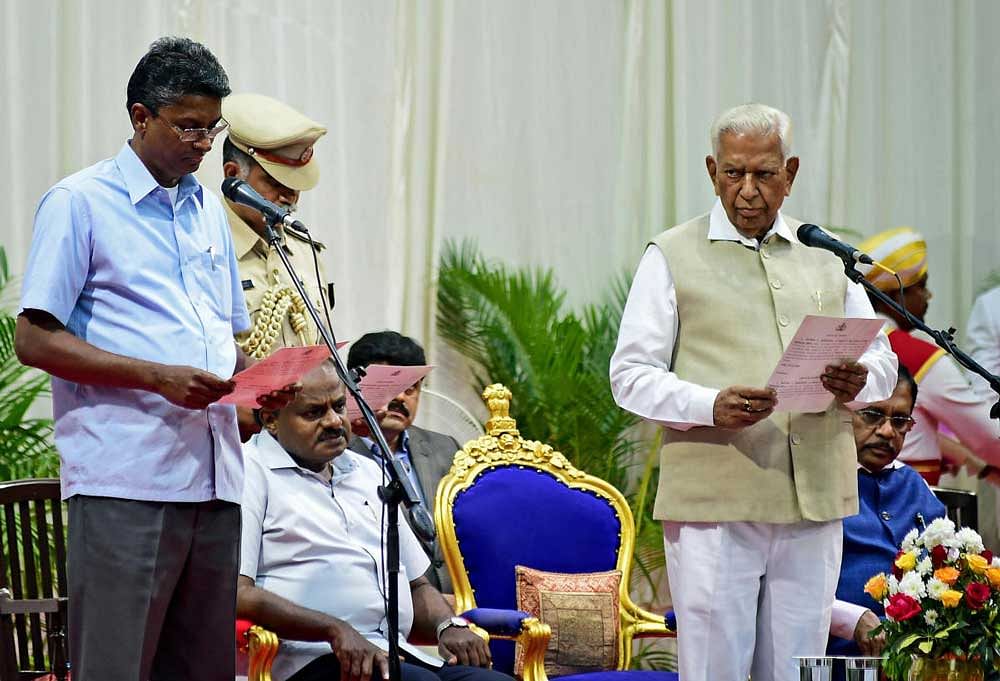 Satish Jarkiholi, who belongs to the Valmiki (ST) community, is sworn-in as minister. DH Photo