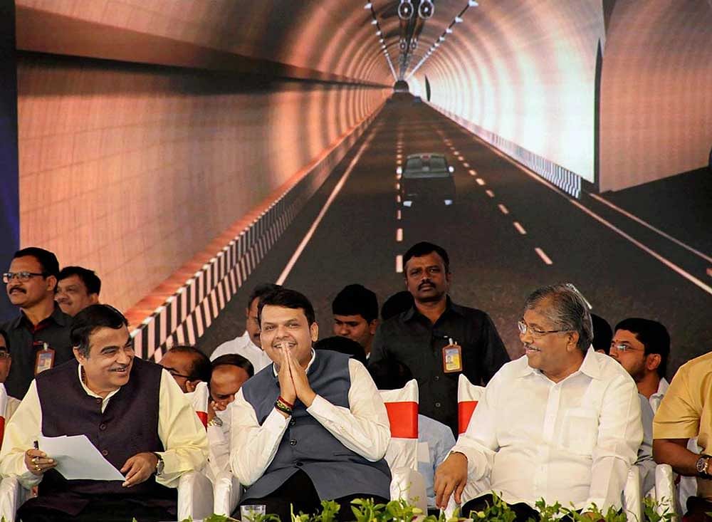 Maharashtra Chief Minister Devendra Fadnavis flanked by Union Transport Minister Nitin Gadkari and Maharashtra Revenue Minister Chandrakant Patil, during foundation stone laying ceremony for construction of 6 lane tunnel in Khambataki Ghat, in Satara. PTI Photo