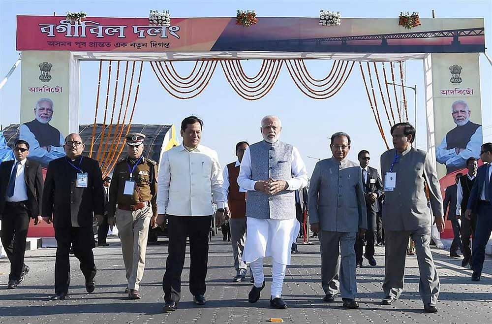 Prime Minister Narendra Modi along with Assam Governor BL Purohit and Chief Minister Sarbananda Sonowal walks on the Bogibeel Bridge, the longest rail-cum-road bridge on Brahmaputra river, after it was inaugurated by him, in Dibrugarh. PTI Photo