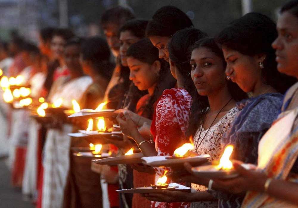 People take part in the 'Ayyappa Jyothi' programme (lighting of lamp) in Kottayam district of Kerala. PTI Photo