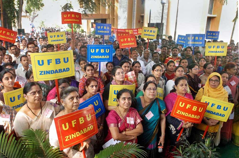 United Forum of Bank Unions (UFBU) members display placards during a protest against the proposed merger of Vijaya Bank and Dena Bank with Bank of Baroda, as part of their nation-wide strike, in Hyderabad. PTI Photo