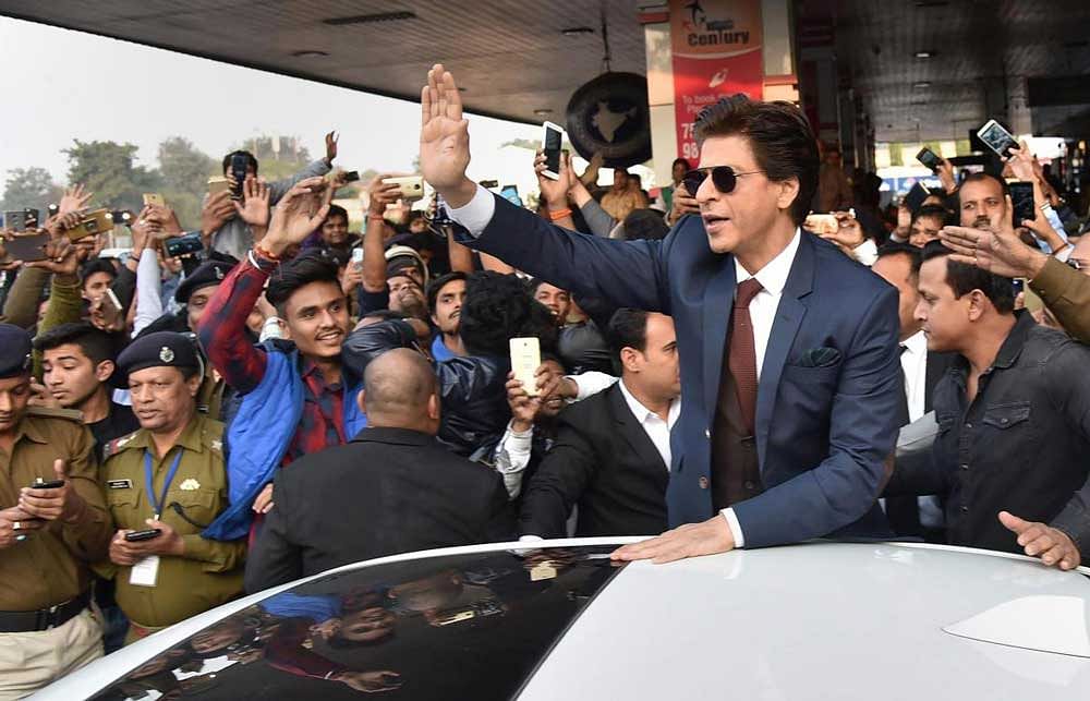 Bollywood actor Shah Rukh Khan greets fans on his arrival for his movie promotion 'Zero', at Jai Prakash Narayan international airport, in Patna. PTI Photo