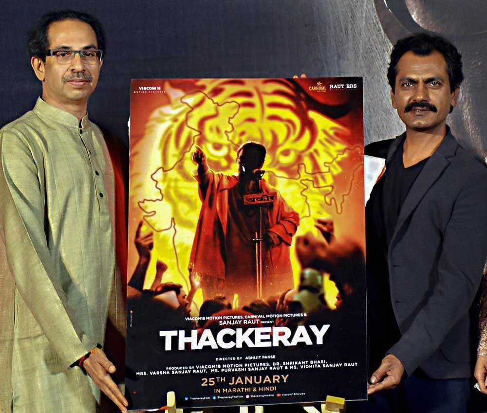 Bollywood actor Nawazuddin Siddiqui (R) and Shiv Sena chief Udhav Thackeray pose during the trailer launch of the upcoming biopic