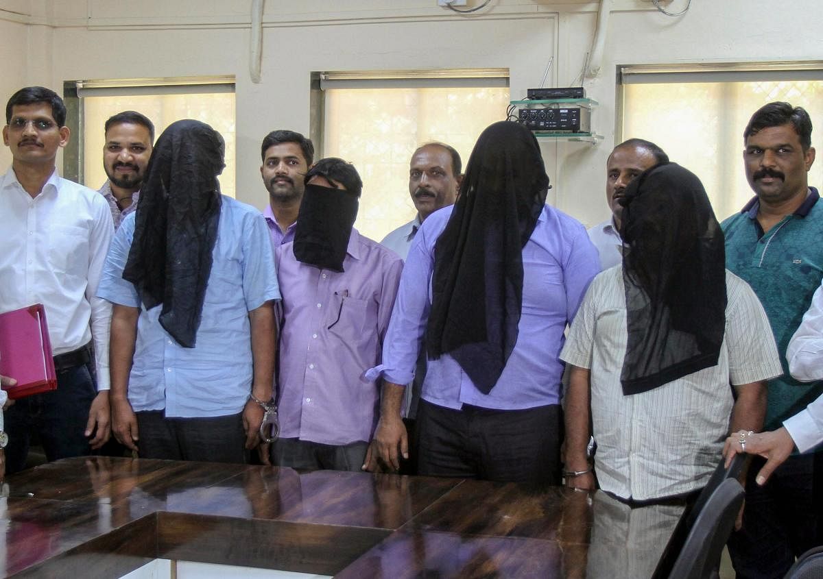Police personnel from Anti-Narcotics Cell of the Crime Branch with the four members caught in possession of 100 kgs of 'Fentanyl', a drug banned in India, after a raid, in Mumbai. PTI