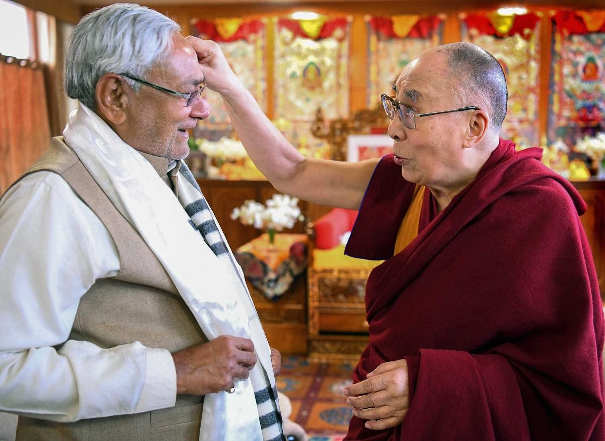 Bihar Chief Minster Nitish Kumar meets the Dalai Lama after the end of his teaching sessions, in Bodhgaya. PTI