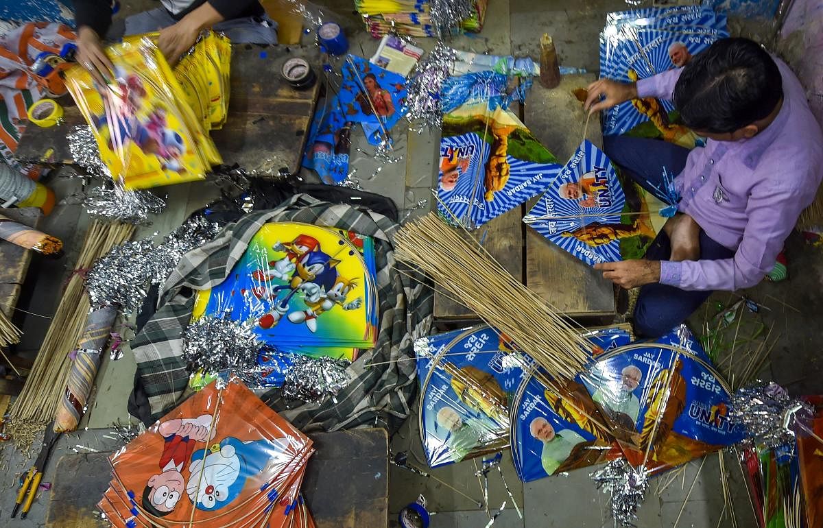 Workers prepare kites at their workshop ahead of kite festival 'Uttarayan', in Ahmedabad. PTI