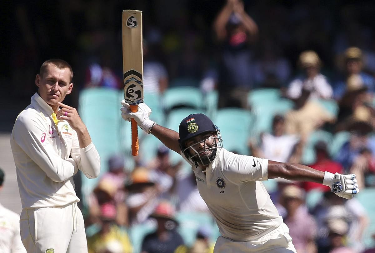 India's Rishabh Pant, right, celebrates making 100 runs as Australia's Marnus Labuschagne turns away on day 2 during their cricket test match in Sydney, Friday, Jan. 4, 2019. (AP/PTI Photo)
