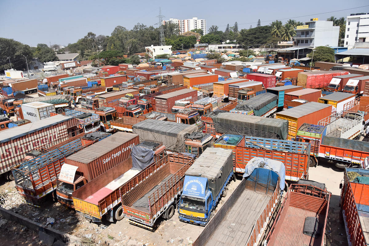 Trucks parked at Goraguntepalya Truck Terminal during the 48-hour nationwide strike called by Central Trade Unions in Bengaluru on Tuesday. (DH Photo/ B H Shivakumar)