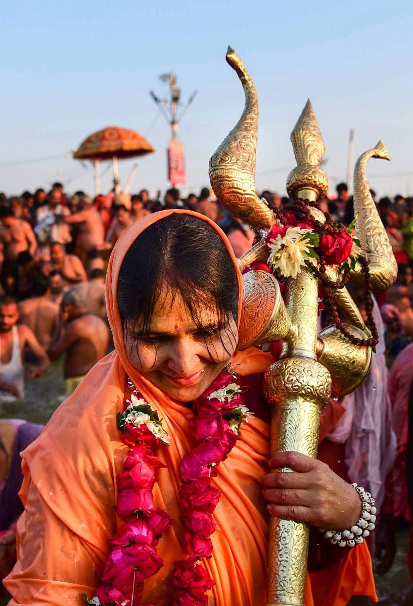 A Sadhvi of Juna Akhara takes a holy dip holding a trident at Sangam on the auspicious Makar Sankranti day during the Kumbh Mela, or pitcher festival in Allahabad. PTI photo