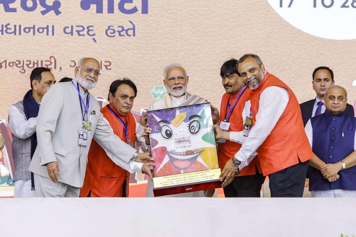 BJP supporters felicitated Prime Minister Narendra Modi at the inaugural function of Amdaavad Shopping Festival, in Ahmedabad. PTI photo