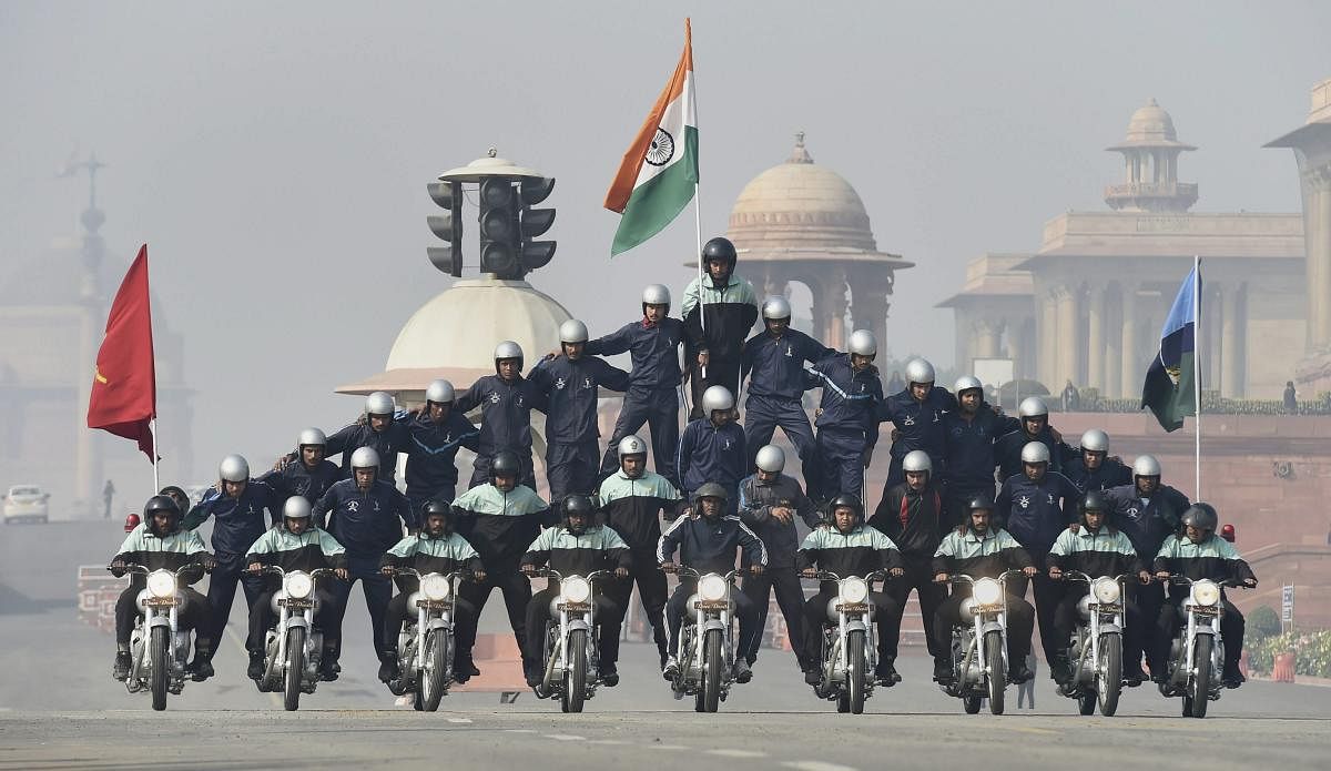 Army daredevils perform a stunt on motorcycles during rehearsals for the upcoming Republic Day parade 2019, on a cold, foggy morning, at Rajpath in New Delhi. (PTI Photo/Kamal Singh)