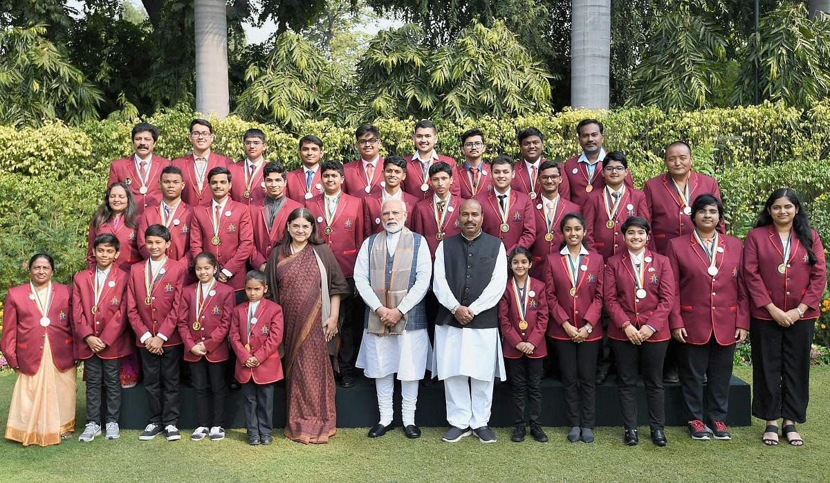 Prime Minister Narendra Modi and Union Women and Child Development Minister Maneka Gandhi pose for a group photograph with the winners of Rashtriya Bal Puraskar - 2019, in New Delhi. (PIB Photo via PTI)